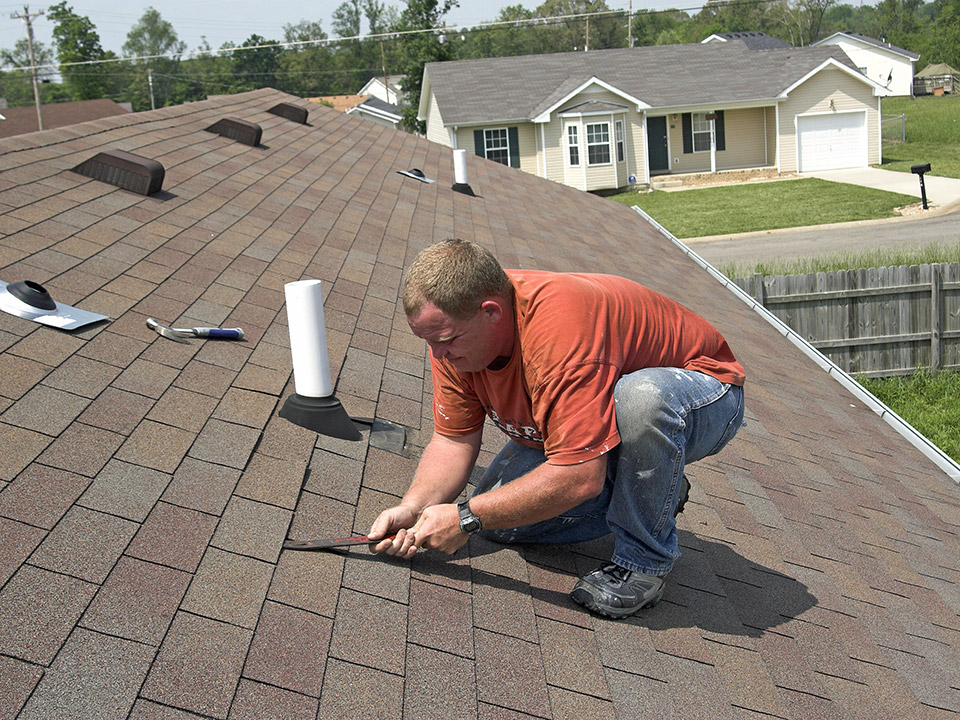 man working on repairing roof