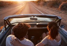 couple driving together with sunset