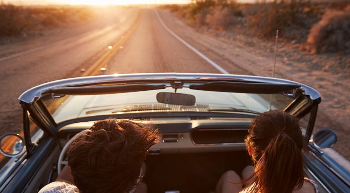 couple driving together with sunset