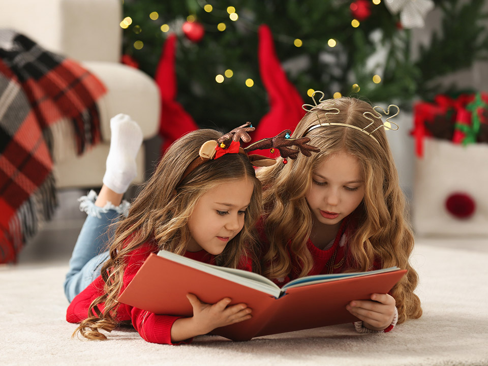 kids reading a book during holidays