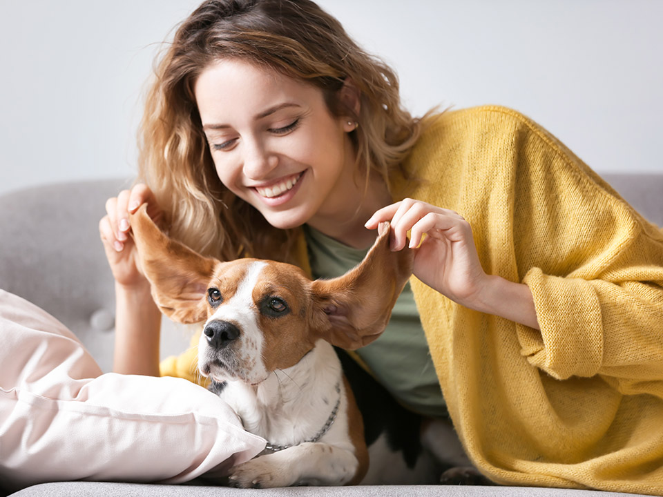 happy woman playing with dog