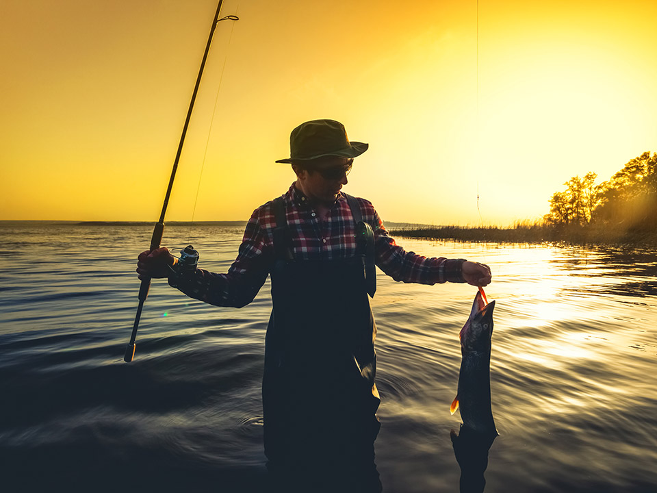 man fishing at sunrise