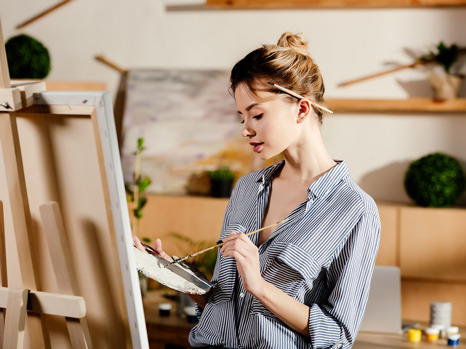 woman painting in studio