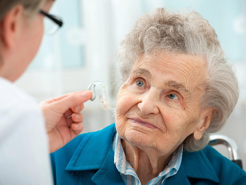 senior woman with hearing aid